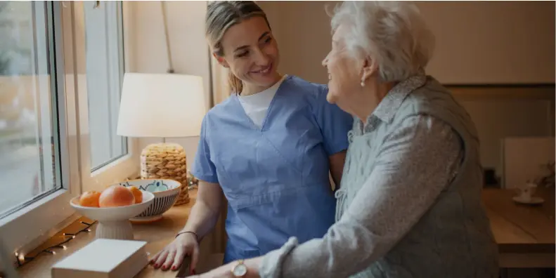 Carer and older lady chatting in the kitchen