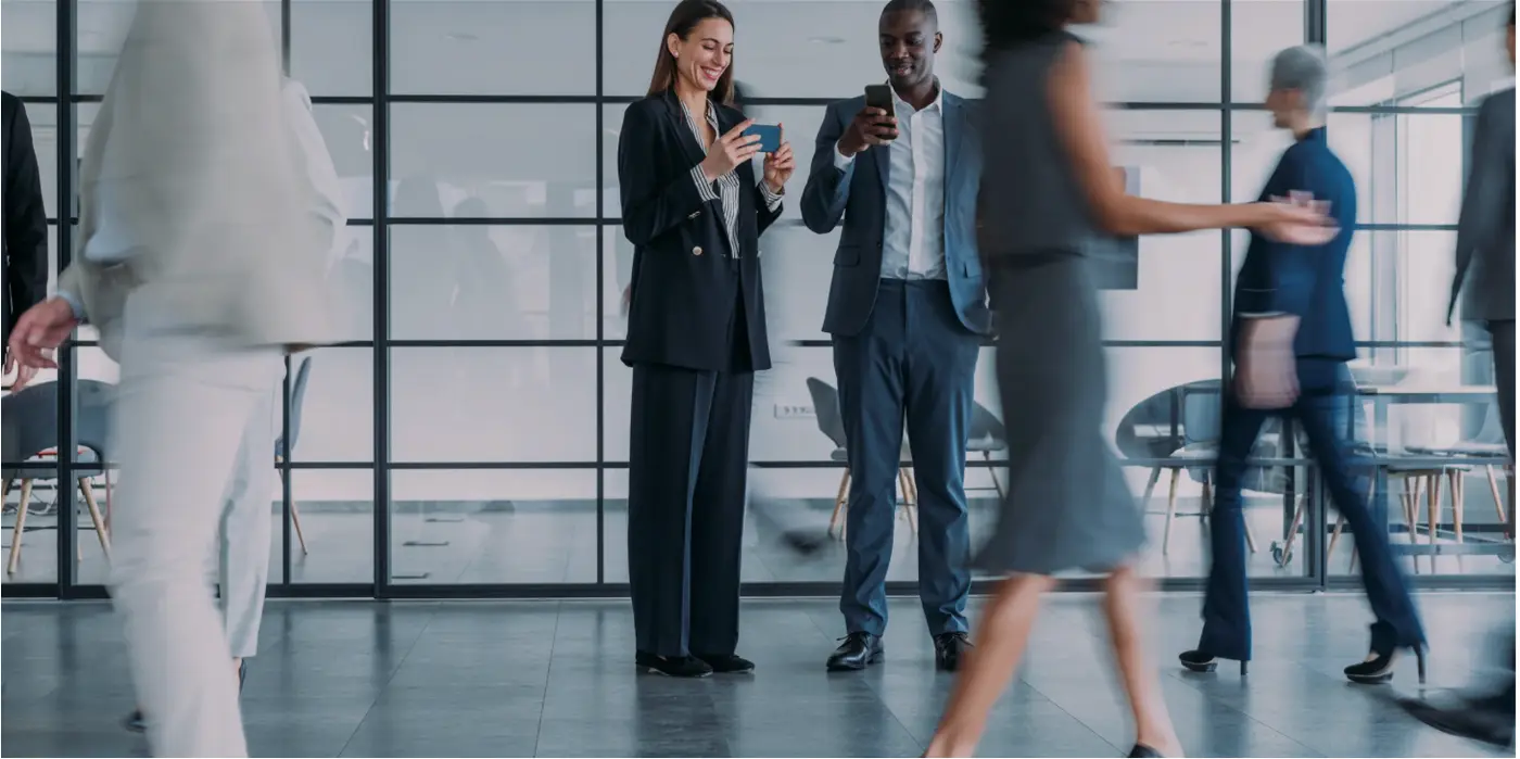 People talking in a busy office People talking in a busy office