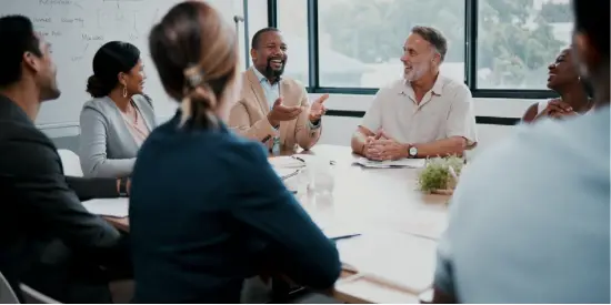 Meeting around board room table Meeting around board room table