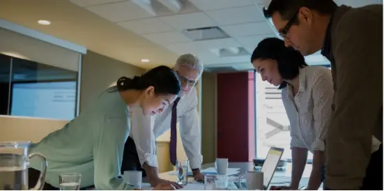 People huddled around desk