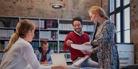 People working around table in modern office