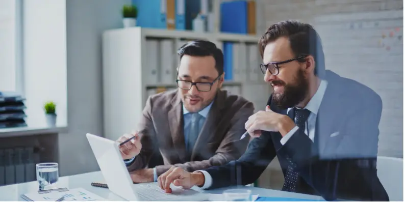 Two business men working with laptop