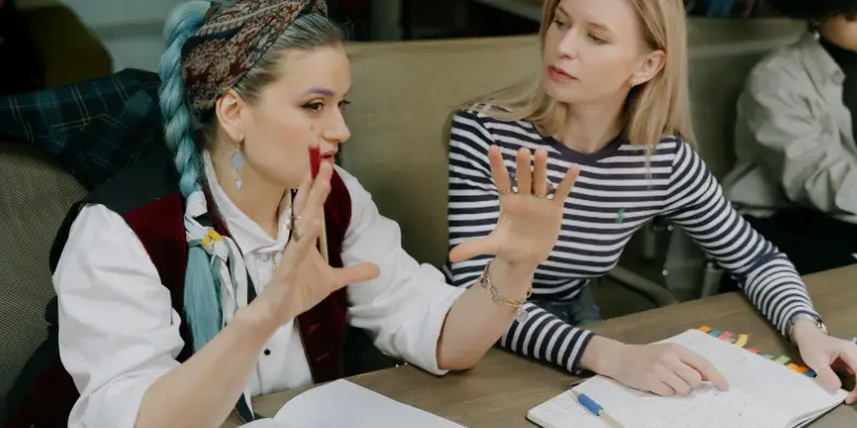 Two ladies chatting at work