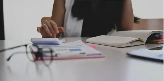 Lady at desk researching in books