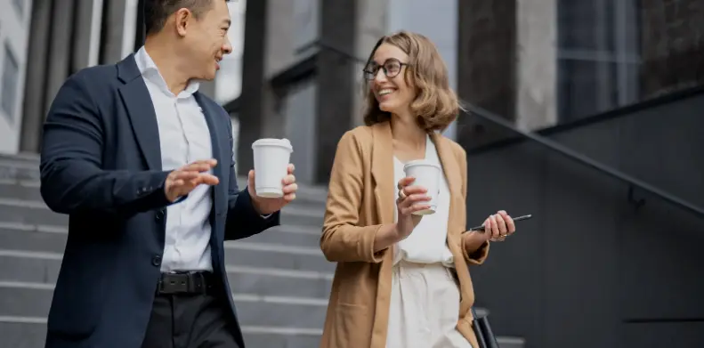 Business people walking down steps with coffee outdoors