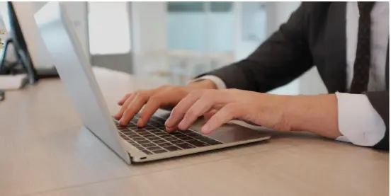 Hands working on laptop