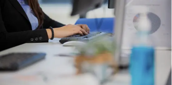 Individuals hands busy at desk