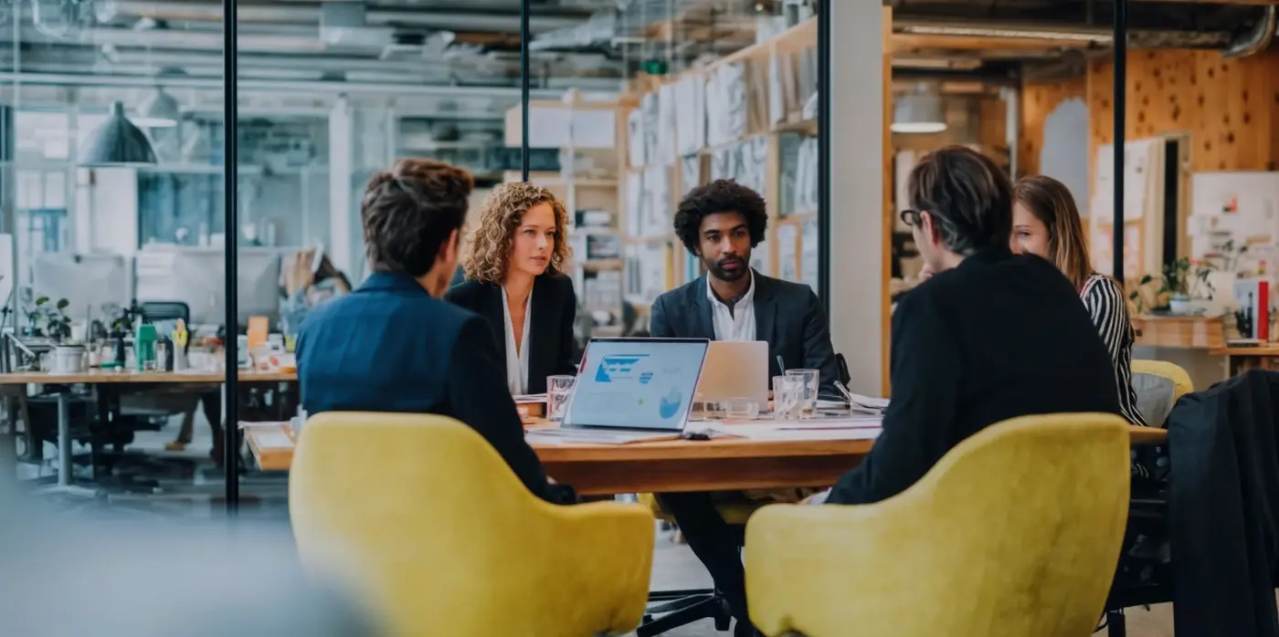 People working around small table at office People working around small table at office