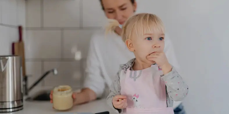 Guardian with a very young child in the kitchen