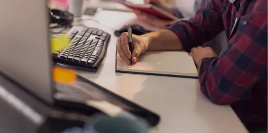 Desk with laptops and post it notes
